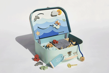The Ocean Lovers Suitcase opening to reveal the play area inside with contents